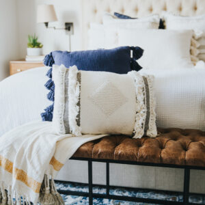Throw pillows at the end of a bed's bench.